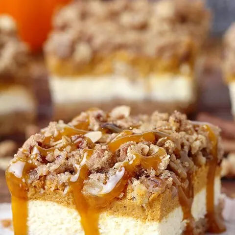 Pumpkin Cheesecake Bars – this holiday dessert with graham crackers and pecan crust, classical creamy cheesecake layer, pumpkin cheesecake layer and streusel topping with oats and pecans will fulfill all your expectations. It’s a perfect Thanksgiving dessert.