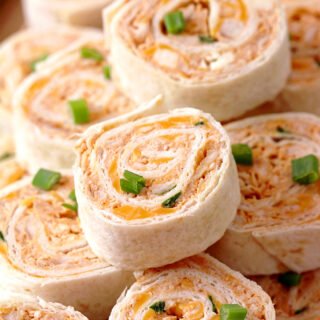 Buffalo Chicken Tortilla Roll Ups – looking for a perfect appetizer that is quick and easy to make? You’re in the right place! These Buffalo Chicken Tortilla Roll Ups are made with cream cheese, cheddar cheese, blue cheese, hot sauce, green onions, chicken, garlic powder and tortillas.