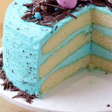Speckled Egg Easter Cake – layers of soft vanilla cake with silky butter vanilla cream colored in blue and speckled pastel Easter eggs are a perfect choice for Easter dessert!