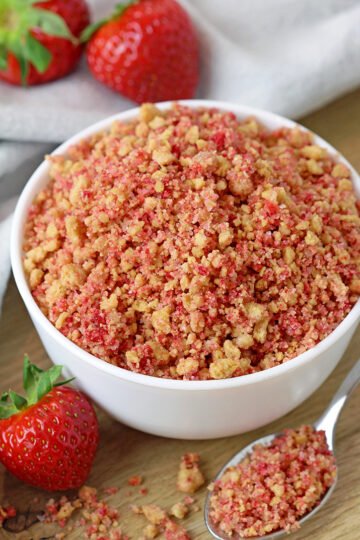 Homemade Strawberry Crunch - it takes only 3 ingredients and 15 minutes of your time to make this perfect crunchy topping for your favorite desserts. It is also called strawberry shortcake crumble. Add it to your yoghurt, sprinkle over ice - cream, pie, cheesecake, cupcake or your favorite cake and you can enjoy its incredibly crunchy taste.