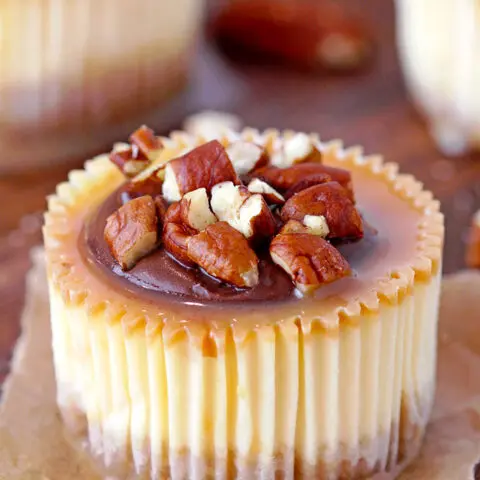Turtle Mini Cheesecakes – graham cracker crust, creamy cheesecake, turtle topping made of caramel sauce, chocolate and pecans make these rich mini cheesecakes simply irresistible. They’re perfect for holidays and special events.