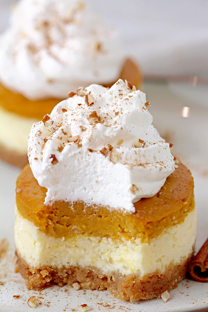 Mini Pumpkin Pie Cheesecakes with decadent creamy filling made of cream cheese and pumpkin pie layers on crunchy graham cracker crust, topped with whipped cream are so delicious and yet simple fall dessert, perfect for Thanksgiving