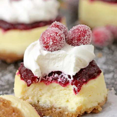 Cranberry Jam and White Chocolate Mousse Mini Cheesecakes are just perfect for Christmas! These Christmas Mini Cheesecakes are so delicious and you really have to try them. Buttery crust, creamy cheesecake layer, fresh cranberry jam and a  rich layer of smooth white chocolate mousse with candied cranberries on top - wooow, amazing dessert!