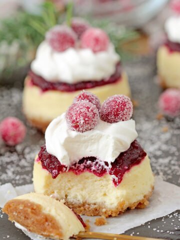 Cranberry Jam and White Chocolate Mousse Mini Cheesecakes are just perfect for Christmas! These Christmas Mini Cheesecakes are so delicious and you really have to try them. Buttery crust, creamy cheesecake layer, fresh cranberry jam and a  rich layer of smooth white chocolate mousse with candied cranberries on top - wooow, amazing dessert!
