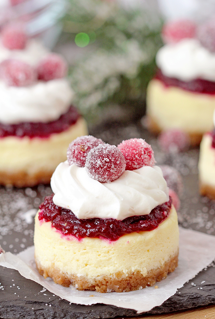 Cranberry Jam and White Chocolate Mousse Mini Cheesecakes are just perfect for Christmas! These Christmas Mini Cheesecakes are so delicious and you really have to try them. Buttery crust, creamy cheesecake layer, fresh cranberry jam and a  rich layer of smooth white chocolate mousse with candied cranberries on top - wooow, amazing dessert!