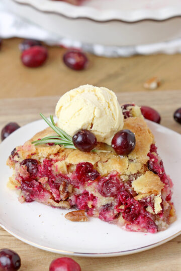 Nantucket Holiday Cranberry Pie - juicy cranberry filling with crunchy pecans and a flaky cake layer on top - in one word perfection! Serve warm with a scoop of vanilla ice cream or whipped topping and you'll enjoy every bite of it.