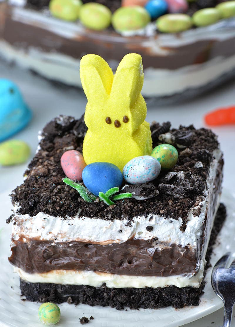 Easter Chocolate Lasagna is a fun and easy no-bake dessert recipe that kids will LOVE! It’s made with crushed Oreos, cream cheese, chocolate pudding and Cool Whip and garnished with Peeps and Easter egg candies.