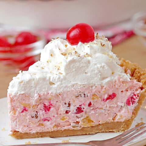 Millionaire pie - this super quick and easy, old fashioned grandma’s recipe with rich, tropical taste can be served for potluck, parties or holidays and it’ll surely be a hit!  This decadent and delicious pie with rich creamy filling made with condensed milk and whipped topping, loaded with pineapple, coconut, pecans and maraschino cherries, on graham cracker crust has a divine taste. 