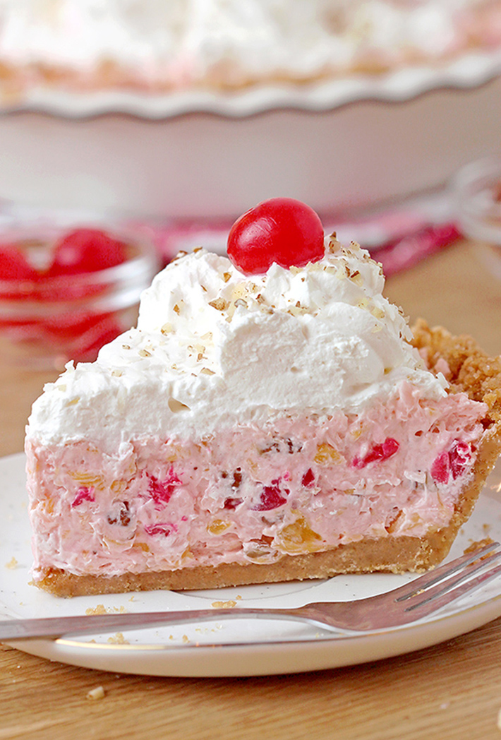 Millionaire pie - this super quick and easy, old fashioned grandma’s recipe with rich, tropical taste can be served for potluck, parties or holidays and it’ll surely be a hit!  This decadent and delicious pie with rich creamy filling made with condensed milk and whipped topping, loaded with pineapple, coconut, pecans and maraschino cherries, on graham cracker crust has a divine taste. 