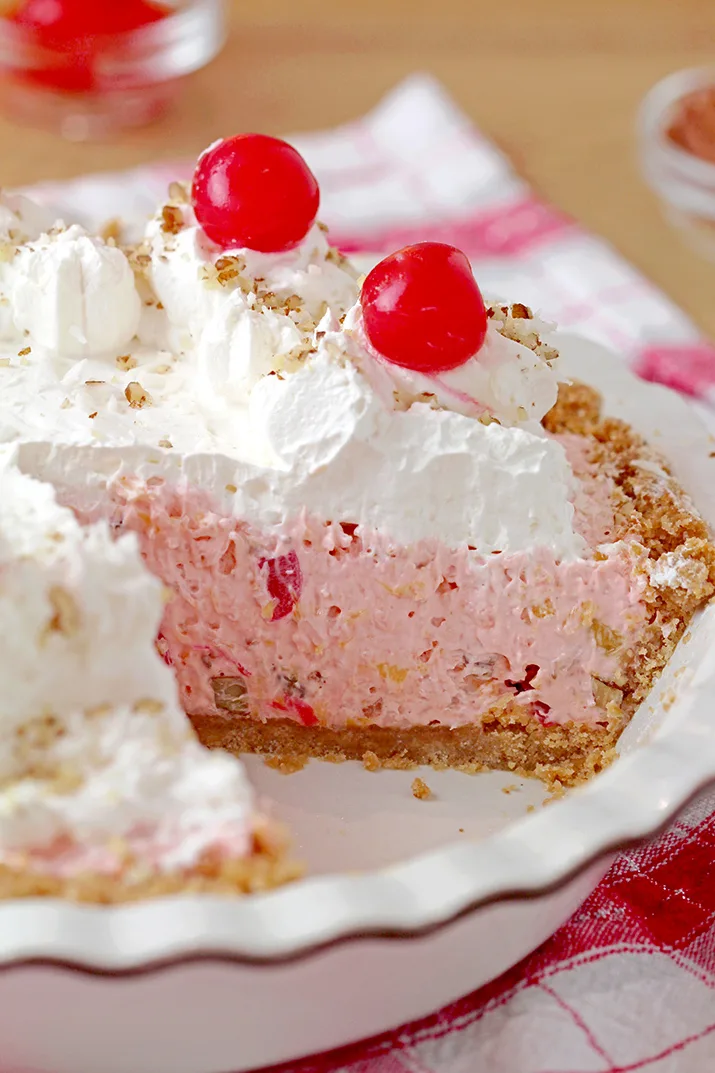 Millionaire pie - this super quick and easy, old fashioned grandma’s recipe with rich, tropical taste can be served for potluck, parties or holidays and it’ll surely be a hit!  This decadent and delicious pie with rich creamy filling made with condensed milk and whipped topping, loaded with pineapple, coconut, pecans and maraschino cherries, on graham cracker crust has a divine taste. 