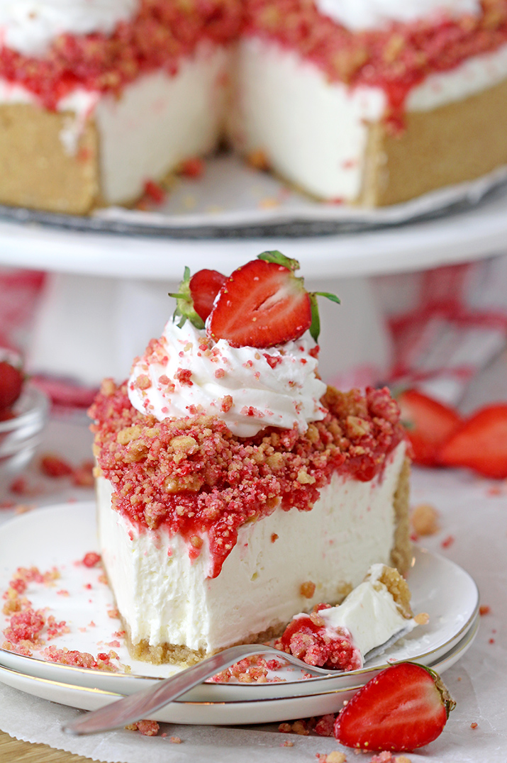 Strawberry Crunch Cheesecake – prepare this easy, no-bake recipe for BBQs, holidays or parties and it’ll be a huge hit!!! Graham cracker crust, creamy, smooth cheesecake filling, strawberry sauce and strawberry crunch topping with whipped topping and fresh strawberries on top make this delicious dessert. 