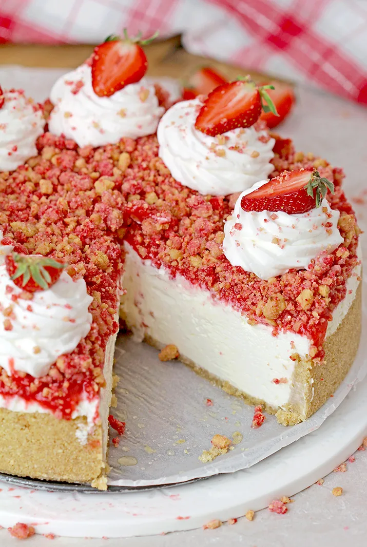 Strawberry Crunch Cheesecake - prepare this easy, no-bake recipe for BBQs, holidays or parties and it’ll  be a huge hit!!! Graham cracker crust, creamy, smooth cheesecake filling, strawberry sauce and  strawberry crunch topping with whipped topping and fresh strawberries on top make this delicious dessert.