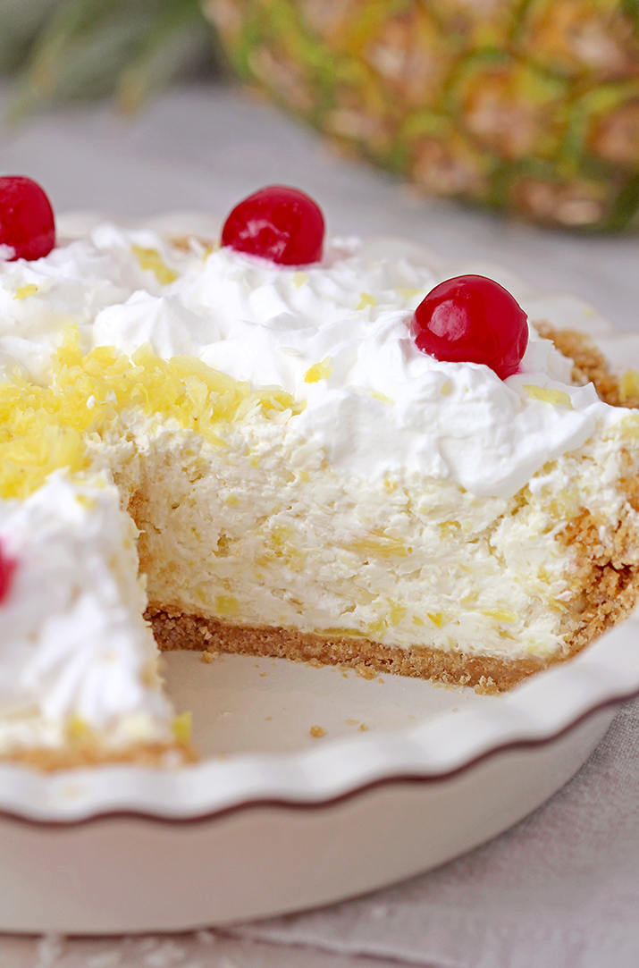 Pineapple Cream Pie – super quick and easy no bake recipe, ready in 10 minutes! Serve this creamy tropical flavor dessert for holidays, gatherings and parties, all year round, especially during summer and be sure your guests will enjoy it. A rich decadent creamy filling made of cream cheese and cool whip loaded with crushed pineapple and grated coconut on a graham cracker crust, topped with whipped topping and maraschino cherries is a tropical dream!