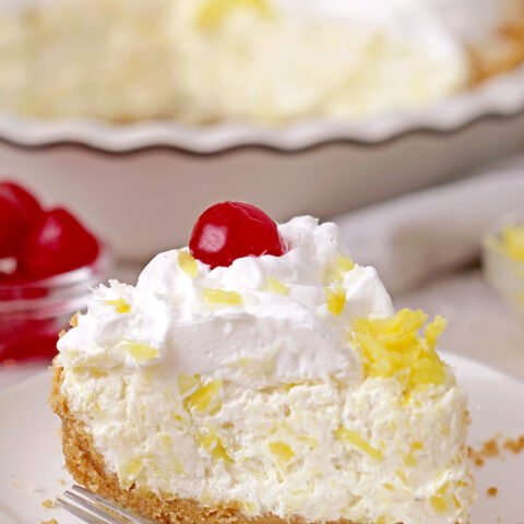 Pineapple Cream Pie – super quick and easy no bake recipe, ready in 10 minutes! Serve this creamy tropical flavor dessert for holidays, gatherings and parties, all year round, especially during summer and be sure your guests will enjoy it. A rich decadent creamy filling made of cream cheese and cool whip loaded with crushed pineapple and grated coconut on a graham cracker crust, topped with whipped topping and maraschino cherries is a tropical dream!