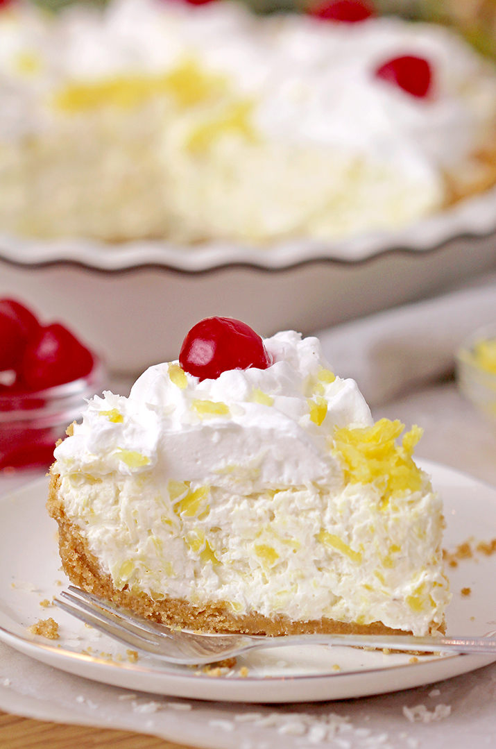 Pineapple Cream Pie – super quick and easy no bake recipe, ready in 10 minutes! Serve this creamy tropical flavor dessert for holidays, gatherings and parties, all year round, especially during summer and be sure your guests will enjoy it. A rich decadent creamy filling made of cream cheese and cool whip loaded with crushed pineapple and grated coconut on a graham cracker crust, topped with whipped topping and maraschino cherries is a tropical dream!