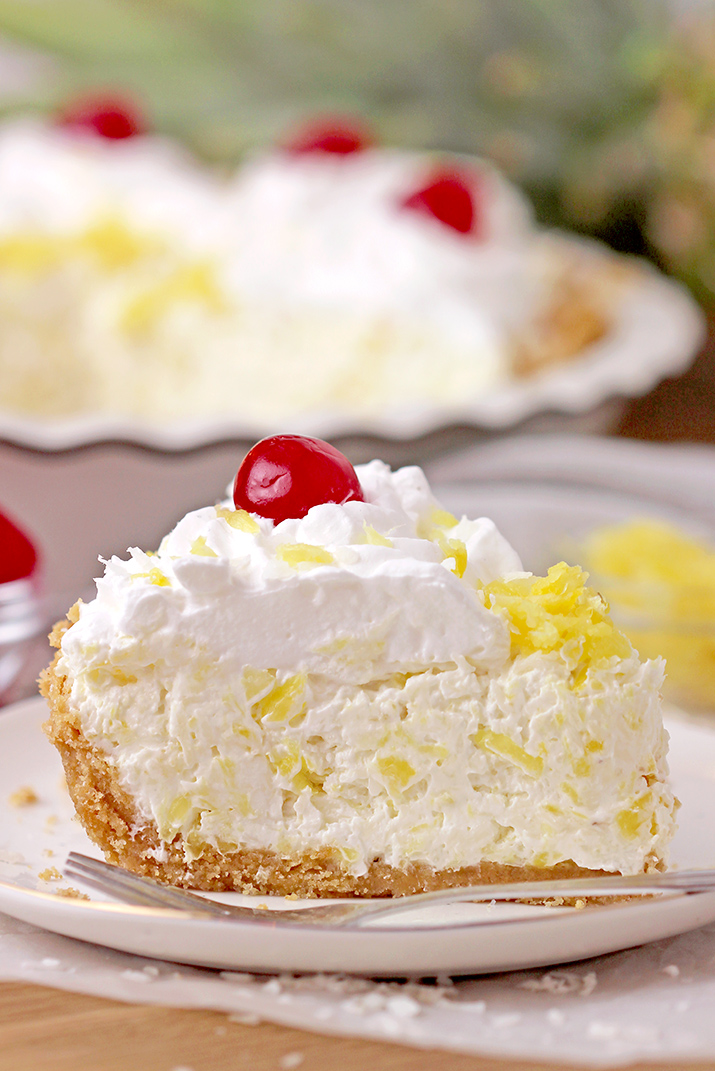 Pineapple Cream Pie – super quick and easy no bake recipe, ready in 10 minutes! Serve this creamy tropical flavor dessert for potluck, holidays and parties, all year round, especially during summer and be sure your guests will enjoy it. A rich decadent creamy filling made of cream cheese and cool whip loaded with crushed pineapple and grated coconut on a graham cracker crust, topped with whipped topping and maraschino cherries is a tropical dream!