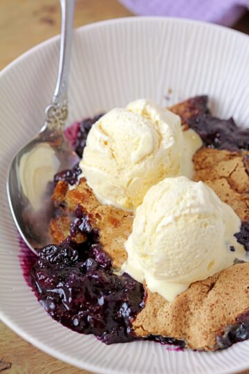 This old fashioned Blueberry Cobbler is the easiest recipe for the tastiest dessert from ingredients you already have on hand, it’s simply perfect. Sweet, juicy blueberries coated with crunchy buttery batter are best served warm with a scoop of vanilla ice cream.