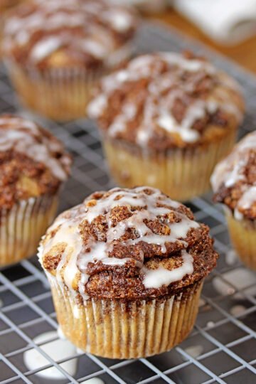 These Cinnamon Roll Muffins are soft, fluffy muffins loaded with cinnamon and brown sugar mixture, the topping and smooth sugar glaze. They will win you over with their taste and easy preparation.