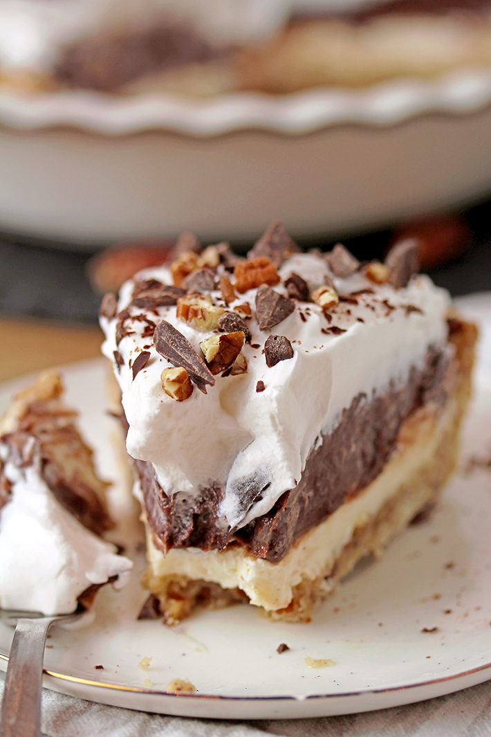 Arkansas Possum Pie - this easy southern pie with 4 layers is perfect for upcoming holidays. Prepare it for Thanksgiving and you’ll be pleasantly surprised.. Buttery pecan shortbread crust, cream cheese layer, decadent chocolate pudding layer topped with fluffy whipped cream, some more chocolate and pecans, in one word - perfection!