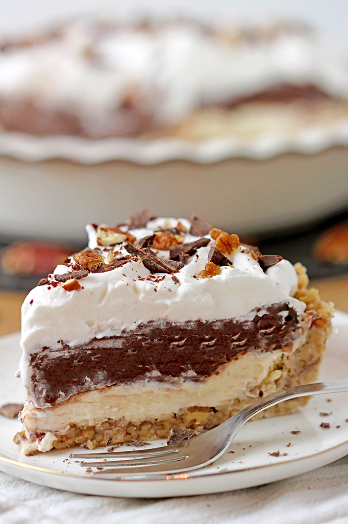 Arkansas Possum Pie - this easy southern pie with 4 layers is perfect for upcoming holidays. Prepare it for Thanksgiving and you’ll be pleasantly surprised.. Buttery pecan shortbread crust, cream cheese layer, decadent chocolate pudding layer topped with fluffy whipped cream, some more chocolate and pecans, in one word - perfection!