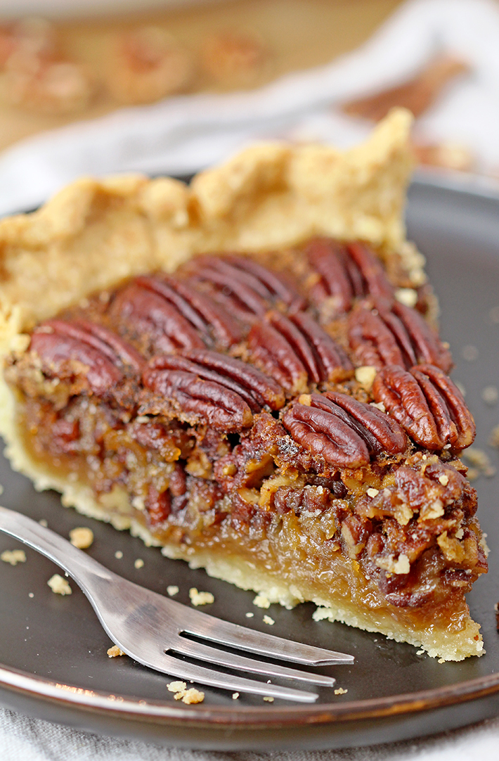 Easy Maple Honey Pecan Pie - flaky, buttery crust, gooey maple honey brown butter filling, crunchy toasted pecans mmmm this pie has to be made for Thanksgiving.