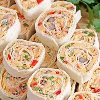 These Mexican Tortilla Roll Ups are the ultimate party appetizer that are quick and easy to make, and they'll win you over with their flavor. These tasty bites are the number 1 finger food for gatherings, parties, celebrations, and holidays. Make these Mexican Tortilla Roll Ups for Game Day, and you'll enjoy every moment.