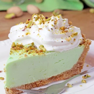 Pistachio Cream Pie is an easy, quick, no - bake dessert with a crunchy graham cracker crust, a creamy filling made with pistachio pudding, cream cheese, and heavy whipping cream, topped with whipped topping and chopped pistachios