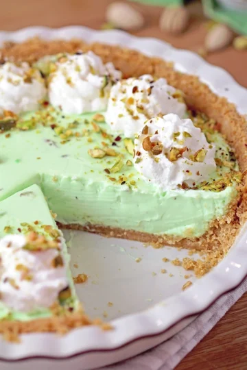 Pistachio Cream Pie is an easy, quick, no - bake dessert with a crunchy graham cracker crust, a creamy filling made with pistachio pudding, cream cheese, and heavy whipping cream, topped with whipped topping and chopped pistachios