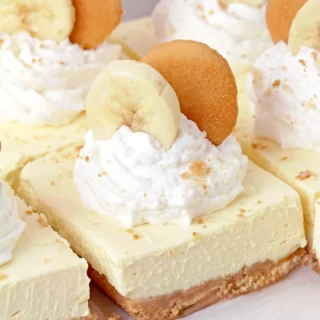 Banana Pudding Cheesecake Bars – with a Nilla wafer crust, a creamy cheese and pudding filling, this dessert is the perfect fusion of two desserts: banana pudding and cheesecake. It's super quick and easy to make, and perfect for any occasion – holidays, birthdays, get-togethers, or whenever you're craving something sweet.