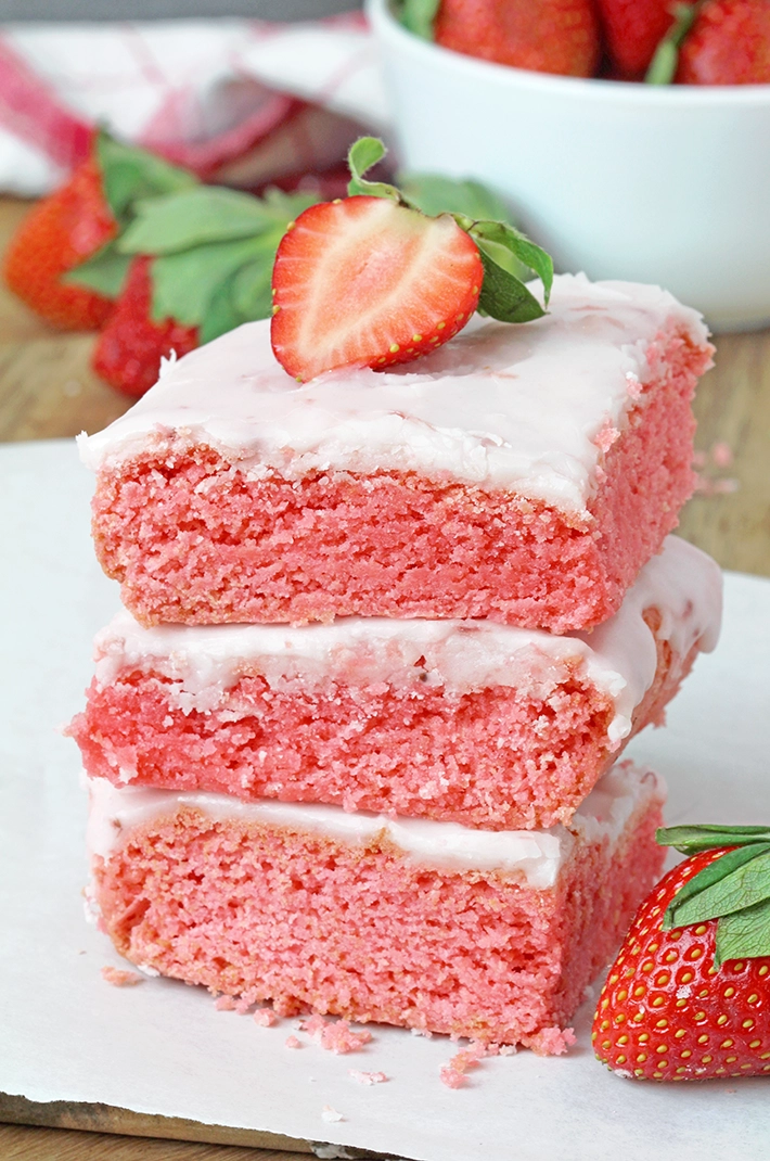 Super Easy Strawberry Brownies - these super moist and easy strawberry brownies are made with strawberry cake mix and a few simple ingredients, topped with a sweet frosting made from strawberry preserves. They're incredibly delicious and unbelievably easy to make - the perfect last minute dessert.