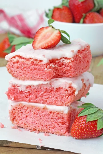 Super Easy Strawberry Brownies - these super moist and easy strawberry brownies are made with strawberry cake mix and a few simple ingredients, topped with a sweet frosting made from strawberry preserves. They're incredibly delicious and unbelievably easy to make - the perfect last minute dessert.
