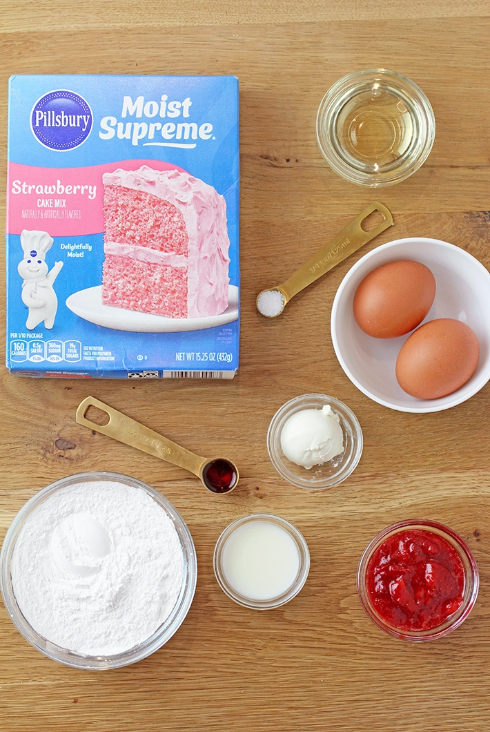 Super Easy Strawberry Brownies - these super moist and easy strawberry brownies are made with strawberry cake mix and a few simple ingredients, topped with a sweet frosting made from strawberry preserves. They're incredibly delicious and unbelievably easy to make - the perfect last minute dessert.