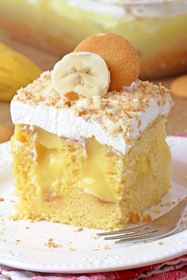 Banana Pudding Poke Cake – quick and easy, moist and soft, made with yellow cake mix, filled with banana pudding, topped with whipped topping, banana slices, and crushed Nilla Wafers. 
