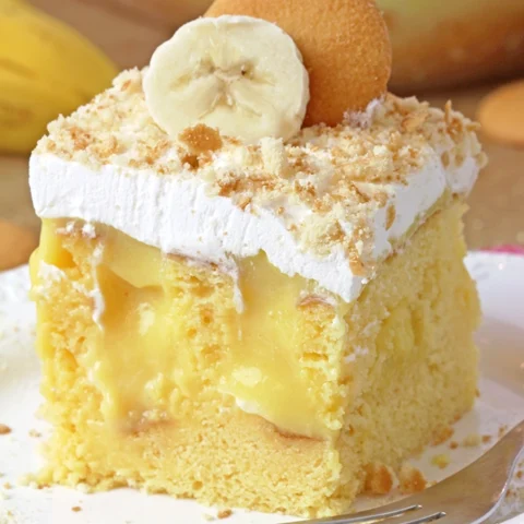 Banana Pudding Poke Cake – quick and easy, moist and soft, made with yellow cake mix, filled with banana pudding, topped with whipped topping, banana slices, and crushed Nilla Wafers. Try this simple and creamy Banana Pudding Poke Cake – a perfect combination of cake, banana pudding, and whipped cream!