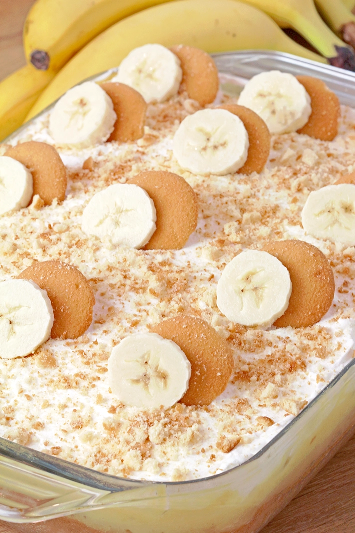 Banana Pudding Poke Cake – quick and easy, moist and soft, made with yellow cake mix, filled with banana pudding, topped with whipped topping, banana slices, and crushed Nilla Wafers. Try this simple and creamy Banana Pudding Poke Cake – a perfect combination of cake, banana pudding, and whipped cream!