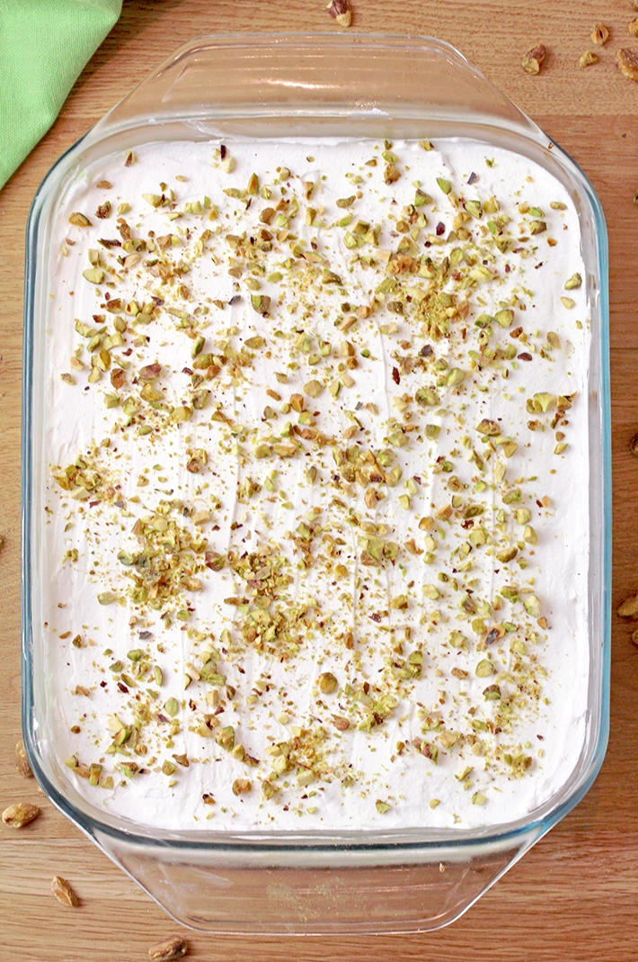 This Pistachio Icebox Cake is a super quick and easy recipe made with layers of graham crackers, instant pistachio pudding filling, and whipped topping in between. It’s topped with whipped topping and chopped pistachios. Made with just 5 simple ingredients in only 10 minutes, it’s perfect when you don’t have much time but want a delicious treat!