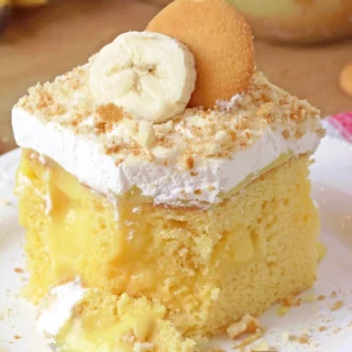 Banana Pudding Poke Cake – quick and easy, moist and soft, made with yellow cake mix, filled with banana pudding, topped with whipped topping, banana slices, and crushed Nilla Wafers. Try this simple and creamy Banana Pudding Poke Cake – a perfect combination of cake, banana pudding, and whipped cream!