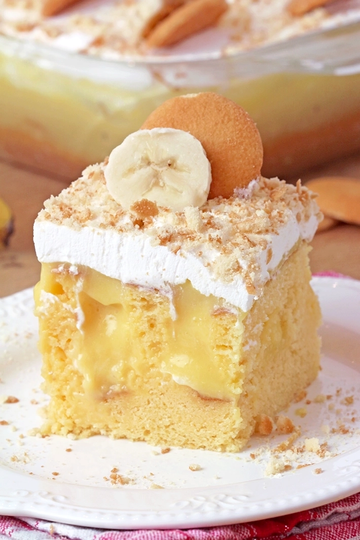 Banana Pudding Poke Cake – quick and easy, moist and soft, made with yellow cake mix, filled with banana pudding, topped with whipped topping, banana slices, and crushed Nilla Wafers. 