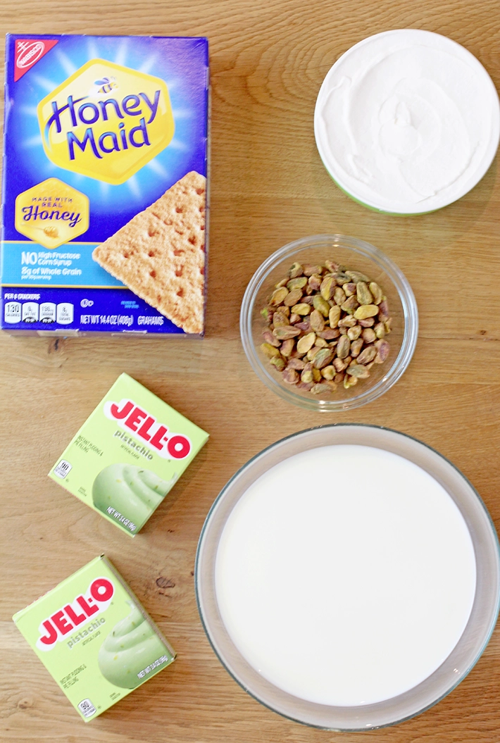 This Pistachio Icebox Cake is a super quick and easy recipe made with layers of graham crackers, instant pistachio pudding filling, and whipped topping in between. It’s topped with whipped topping and chopped pistachios. Made with just 5 simple ingredients in only 10 minutes, it’s perfect when you don’t have much time but want a delicious treat!
