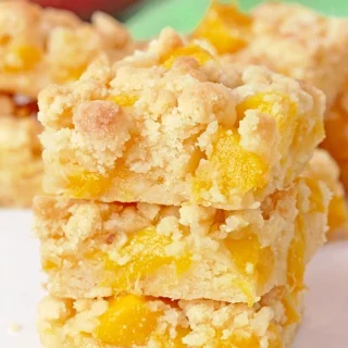 These Mango Crumb Bars, with a buttery crust, filled with juicy chunks of mango and topped with a crumbly streusel, are quick and easy to make and absolutely delicious. If you love mango, this dessert is perfect for you! Serve them with a scoop of vanilla ice cream and enjoy every bite.