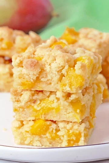 These Mango Crumb Bars, with a buttery crust, filled with juicy chunks of mango and topped with a crumbly streusel, are quick and easy to make and absolutely delicious. If you love mango, this dessert is perfect for you! Serve them with a scoop of vanilla ice cream and enjoy every bite.