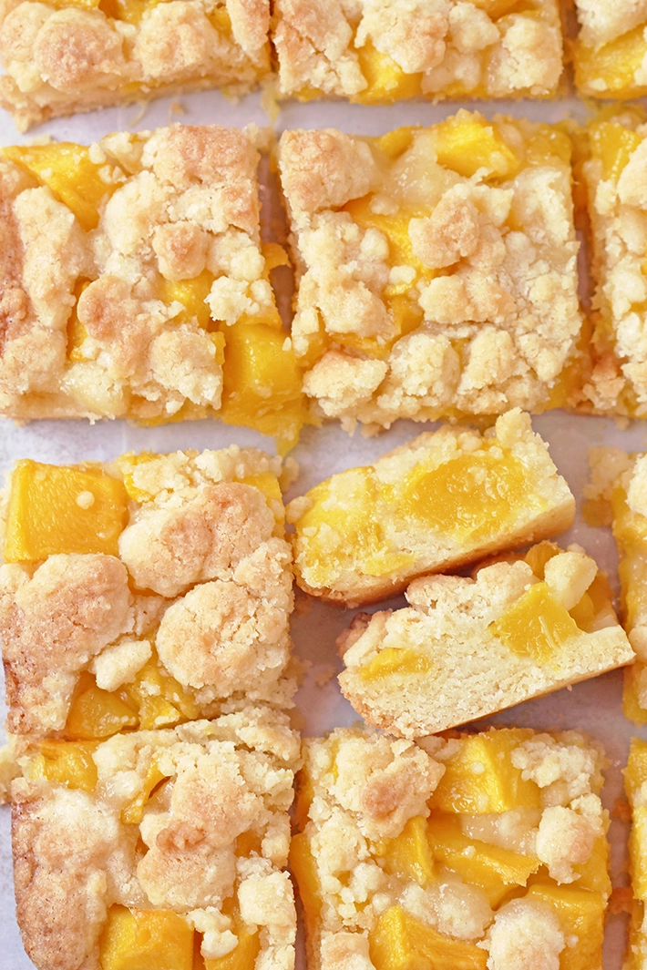 These Mango Crumb Bars, with a buttery crust, filled with juicy chunks of mango and topped with a crumbly streusel, are quick and easy to make and absolutely delicious. If you love mango, this dessert is perfect for you! Serve them with a scoop of vanilla ice cream and enjoy every bite.