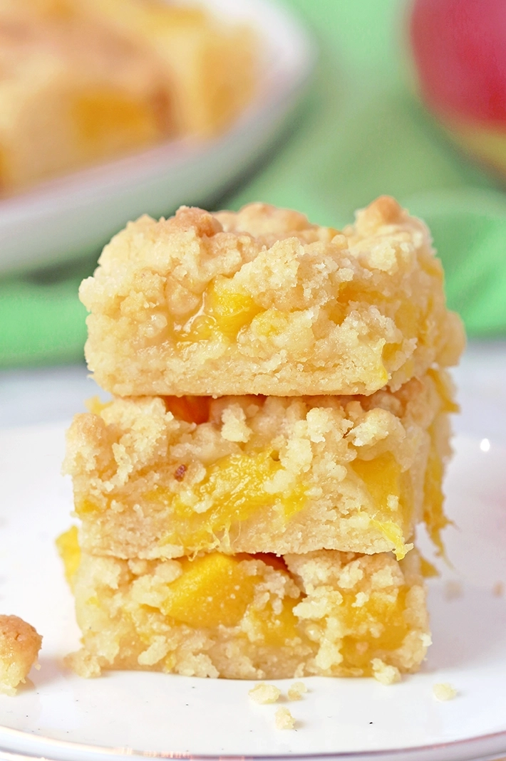 These Mango Crumb Bars, with a buttery crust, filled with juicy chunks of mango and topped with a crumbly streusel, are quick and easy to make and absolutely delicious. If you love mango, this dessert is perfect for you! Serve them with a scoop of vanilla ice cream and enjoy every bite.
