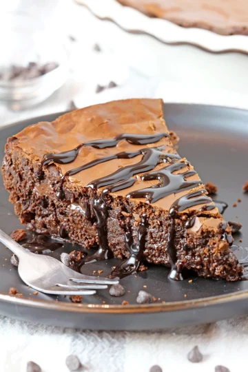 Gooey Chocolate Brownie Pie is one of the most delicious and easiest pies I have ever made. Fudgy texture and crackly top - simply perfection! It is a family favorite so we often prepare it and always enjoy its rich taste. It is typically served with whipped topping or a scoop of vanilla ice cream and drizzled with hot fudge sauce.