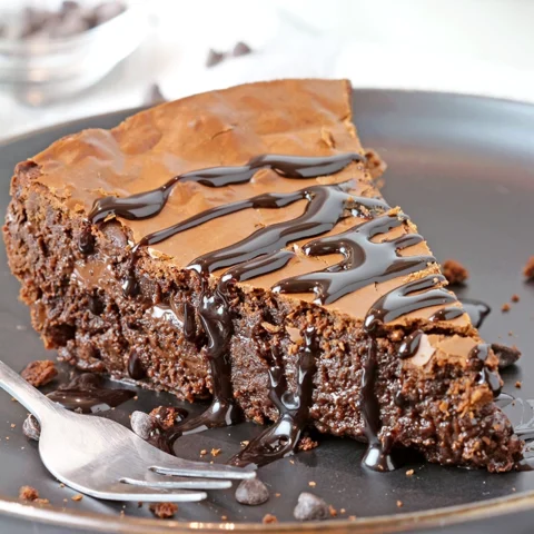 Gooey Chocolate Brownie Pie is one of the most delicious and easiest pies I have ever made. Fudgy texture and crackly top - simply perfection! It is a family favorite so we often prepare it and always enjoy its rich taste. It is typically served with whipped topping or a scoop of vanilla ice cream and drizzled with hot fudge sauce.