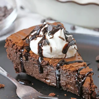 Gooey Chocolate Brownie Pie is one of the most delicious and easiest pies I have ever made. Fudgy texture and crackly top - simply perfection! It is a family favorite so we often prepare it and always enjoy its rich taste. It is typically served with whipped topping or a scoop of vanilla ice cream and drizzled with hot fudge sauce.
