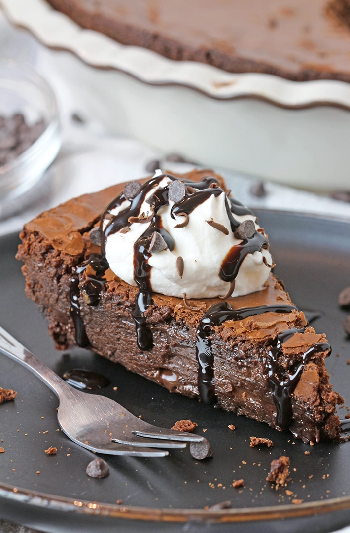 Gooey Chocolate Brownie Pie is one of the most delicious and easiest pies I have ever made. Gooey texture and crackly top - simply perfection! It is a family favorite so we often prepare it and always enjoy its rich taste. It is typically served with whipped topping or a scoop of vanilla ice cream and drizzled with hot fudge sauce.