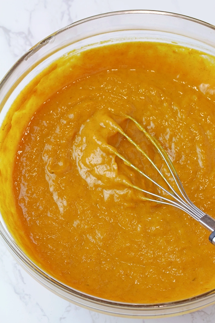 Step 2: Mix the wet and dry ingredients.
Add the pumpkin purée, evaporated milk, eggs, and vanilla to the dry ingredients, and whisk until smooth and well combined.