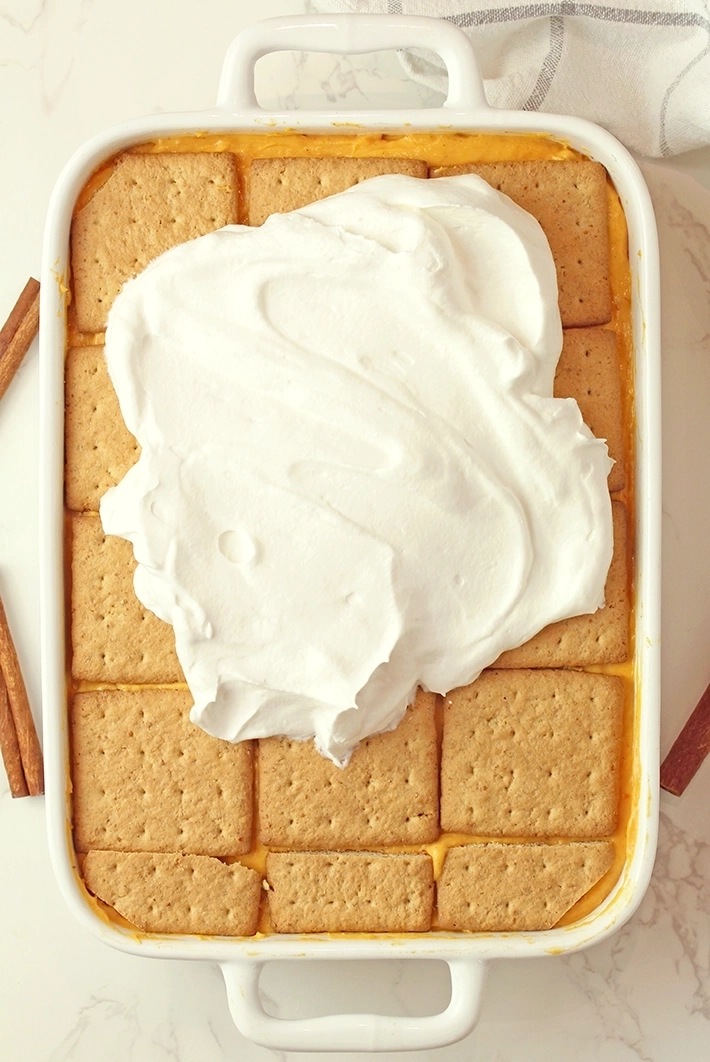 Finish with a final layer of graham crackers. Top with the remaining whipped topping.