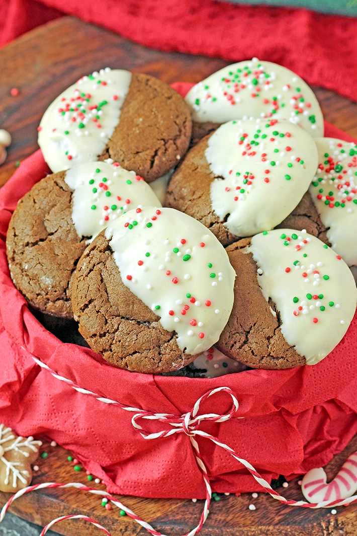 Soft and chewy gingerbread cookies dipped in creamy white chocolate. An easy holiday recipe, perfect for gifts, cookie boxes and Christmas baking.